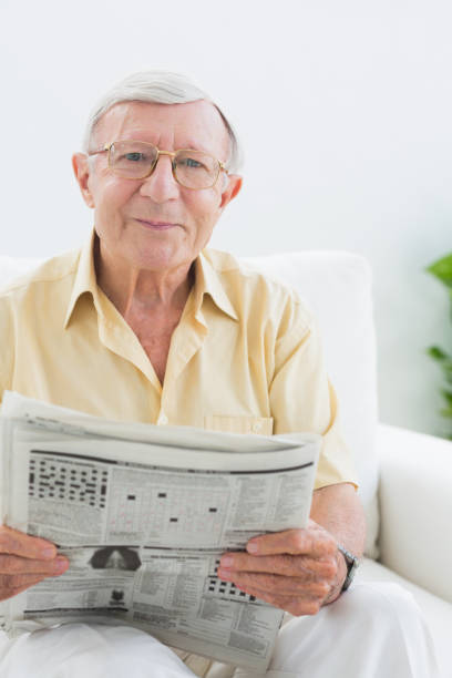 istock Smiling elderly man reading the news 849699330