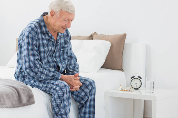 istock Elderly man sitting on the bed 849699530