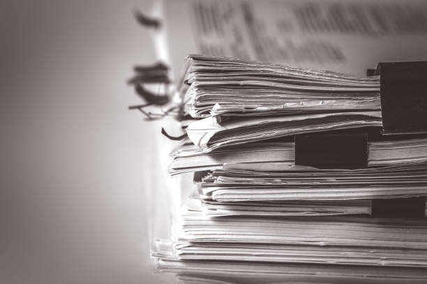 istock extreamely close up the stacking of office working document with paper clip folder, vintage color tone 849700000