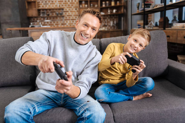 istock Upbeat father and son playing video games 849704278