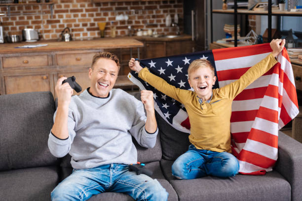 istock Upbeat father and son celebrating on sofa 849704440