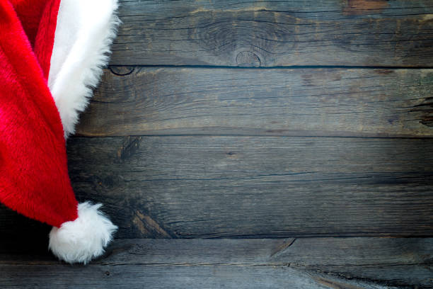 Christmas abstract background with Santa Claus hat on vintage boards