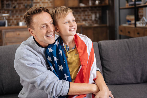 istock Happy father hugging his son in US flag 849705202