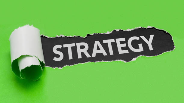 istock Torn green paper revealing the word Strategy 849708510