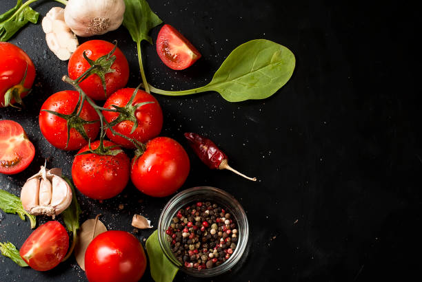 istock cherry tomatoes on a branch, spinach leaves and spice 849711444