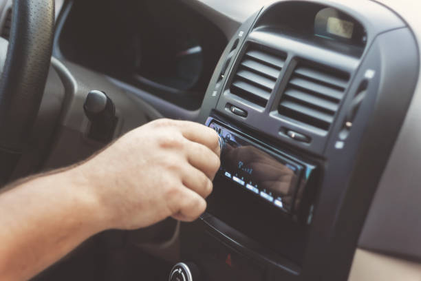 istock man's hand twists the volume in a retro toning car 849711476