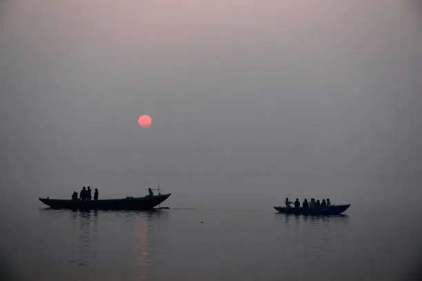 Fishermen in fishing boat, Varanasi, Uttar Pradesh, India