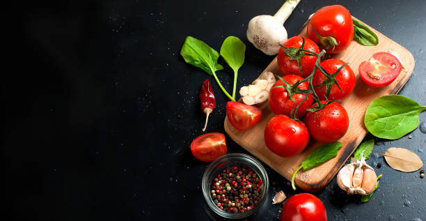 istock cherry tomatoes on a branch, spinach leaves and spice 849711952