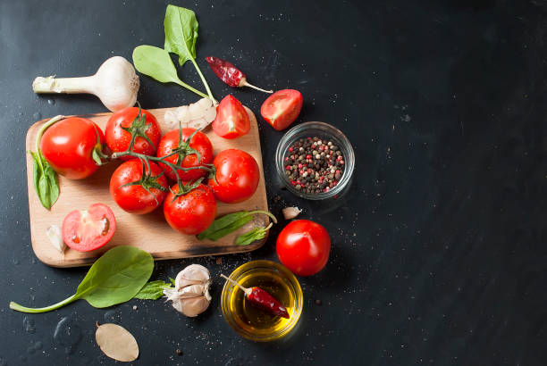 istock cherry tomatoes on a branch, spinach leaves and spice 849712076