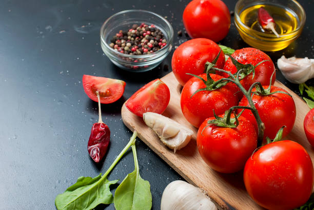 istock cherry tomatoes on a branch, spinach leaves and spice 849712402
