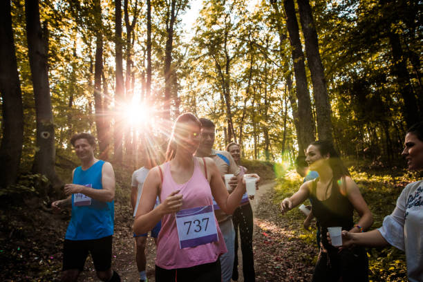 istock Marathon runners taking refreshment during race in the forest. 849715420