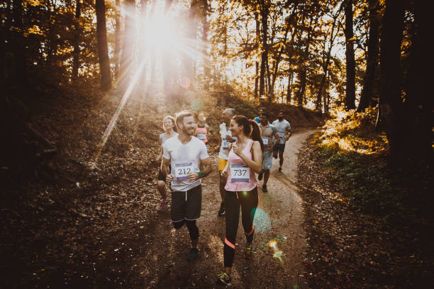 istock Happy athletic couple communicating while running marathon in the forest. 849716198