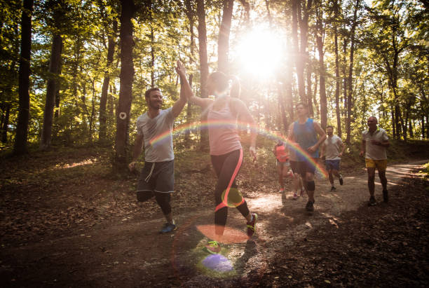 istock Happy couple giving high-five while running marathon race in nature. 849716800