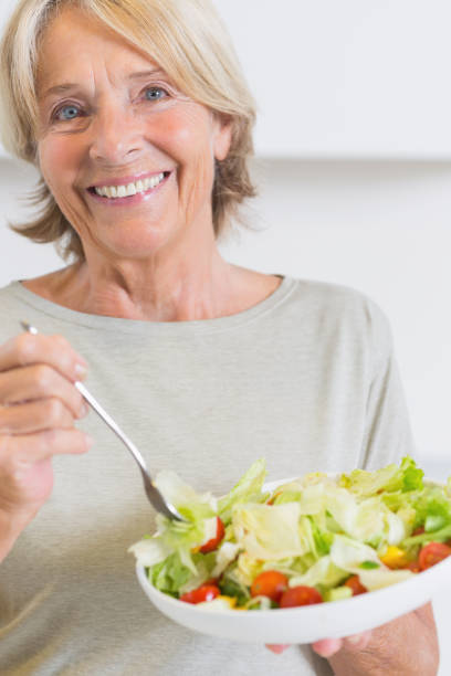 istock Happy mature woman eating salad 849720340