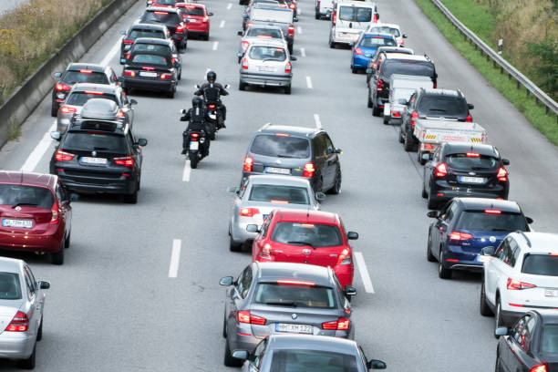 motorbike riders overtake the vehicles in traffic jam - traffic jam traffic germany car imagens e fotografias de stock