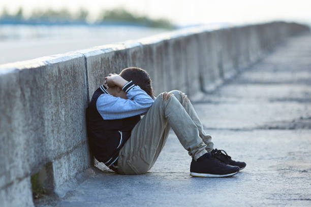 istock young homeless boy  crying on the bridge 849722114