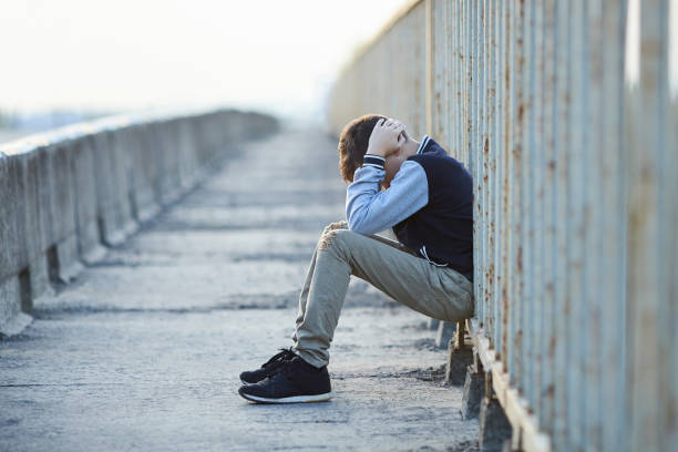 istock young homeless boy  crying on the bridge 849722162