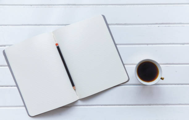 istock Notebook top view with pencil and cup of coffee 849727472