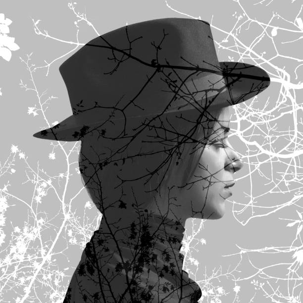 istock Double exposure of girl wearing hat and tree branches 849730696