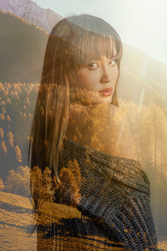 Double exposure of pretty girl looking back and autumnal mountainscape