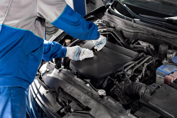 istock Mechanic checking oil level in a car workshop 849731162