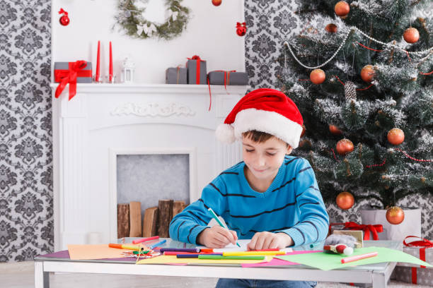 istock Cute boy writing letter to santa, wait for christmas 849739662