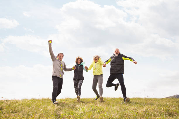 istock Group of senior runners outdoors, resting, holding hands. 849739756