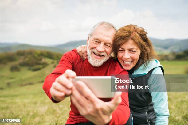 Active Senior Runners In Nature Taking Photo With Smart Phone Stock Photo - Download Image Now