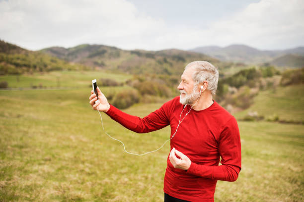 istock Active senior runner in nature taking selfie with smart phone. 849740122