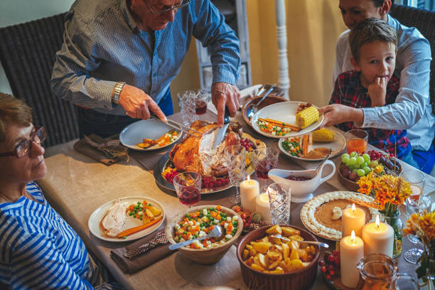 istock Grandfather Carving Stuffed Turkey for Holiday Dinner 849740976