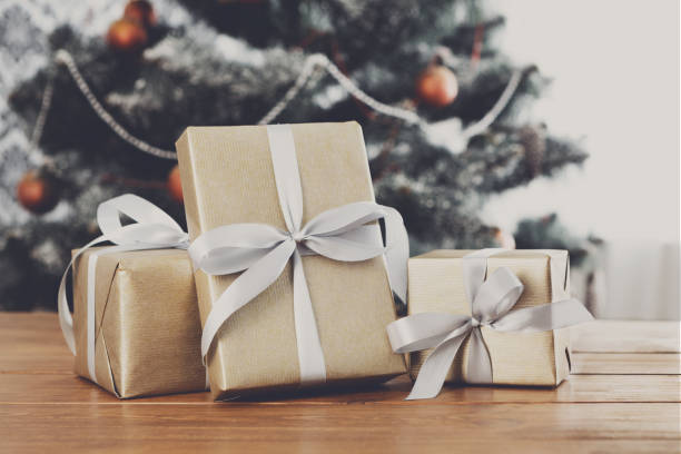 istock Christmas gifts on decorated tree background, holiday concept 849745560