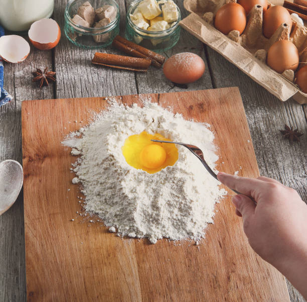 istock Woman baker makes dough with eggs, butter and flour 849748458