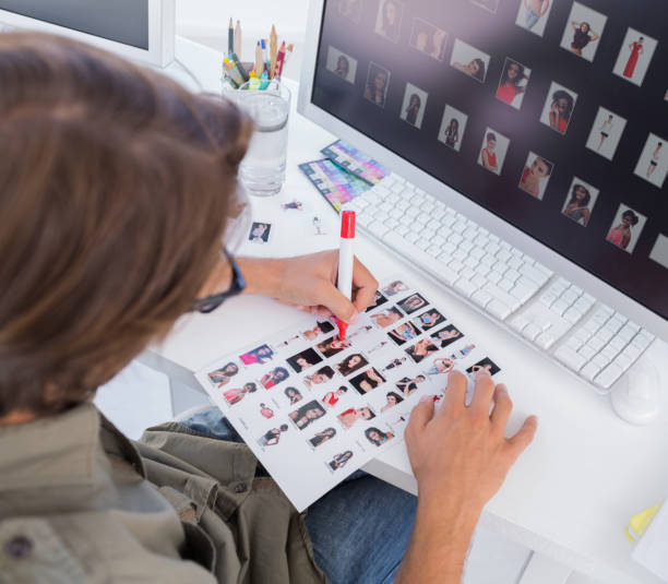 istock Over head of editor marking contact sheet 849749148