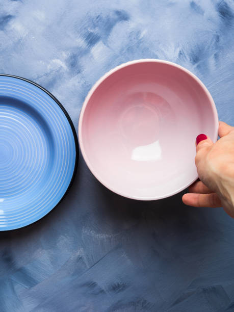 istock Pastel color bowl and plate with woman's hand 849749398