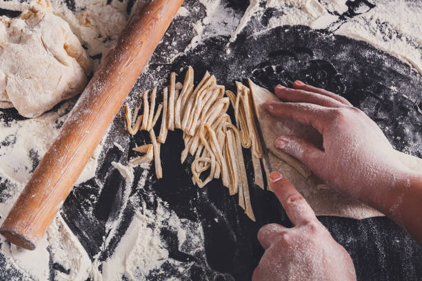 istock Cooking noodles concept on black background, sprinkled flour wit 849749644