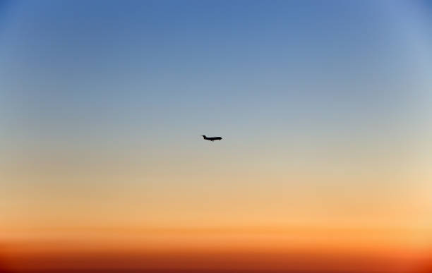 istock Airplane in the sky at sunset 849752710