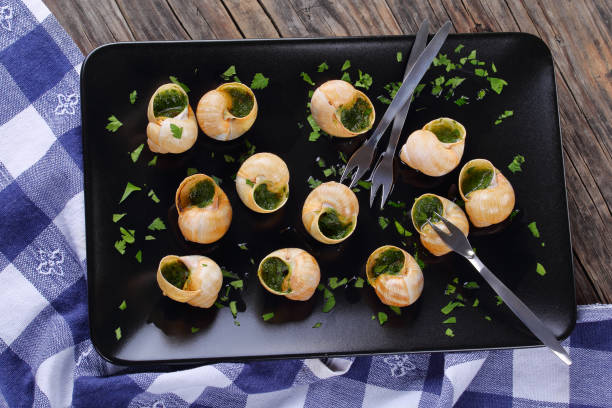 istock Snails with herbs butter garlic, top view 849756680