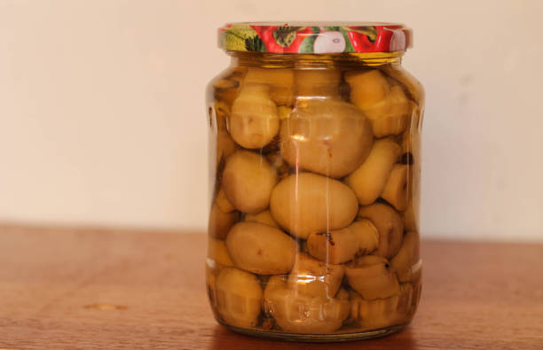 Two glasses of home-made preserves, mushrooms, bolete, for the winter.