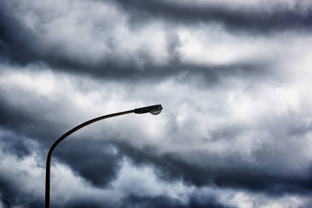 istock Silhouetted streetlamp against moody clouded sky 849757496