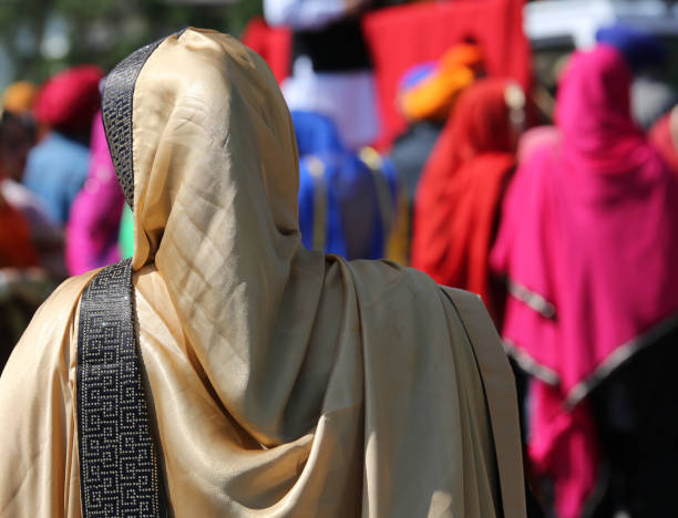 woman with golden veil during a religious event on the streets of the city