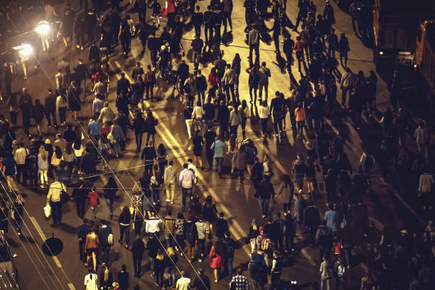 istock Crowd of anonymous people walking on night Voronezh street 849763250