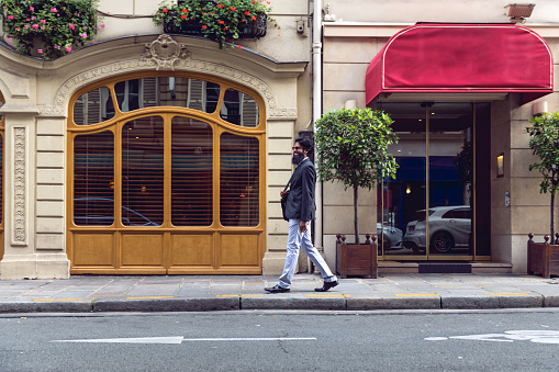 Pakistani man walking to work in the city, in Paris, France.