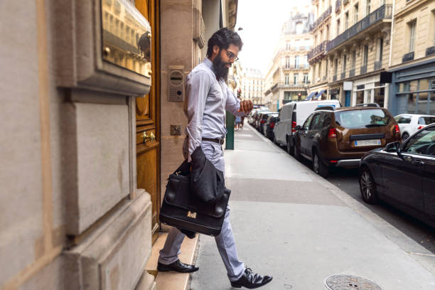 New York, USA - June 8, 2019: A man sits quietly at a table while the city bustles around him.