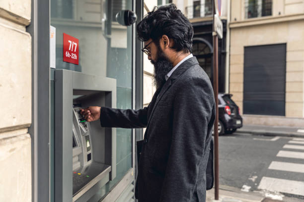 istock Pakistani man withdrawal at ATM in Paris 849763832