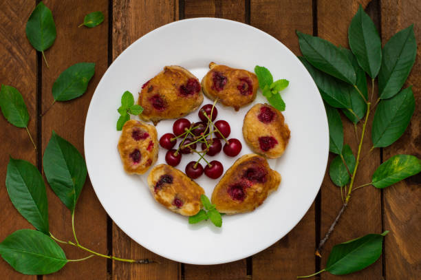 istock Pancakes with cherries. Wooden background. Close-up. Top view 849763898