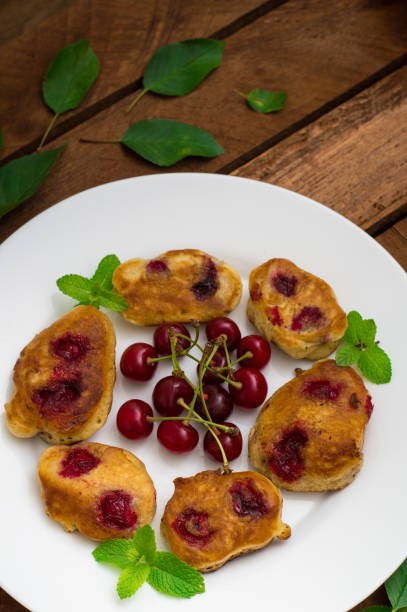 istock Pancakes with cherries. Wooden background. Close-up. Top view 849764010