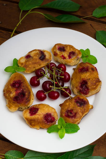 istock Pancakes with cherries. Wooden background. Close-up. Top view 849764164