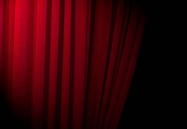 istock Red curtains at a theatre with half light for text or other ideas 849765112