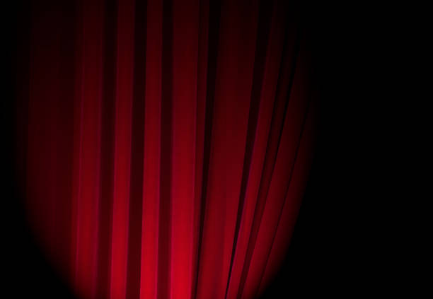 istock Red curtains at a theatre with half light for text or other ideas 849765192