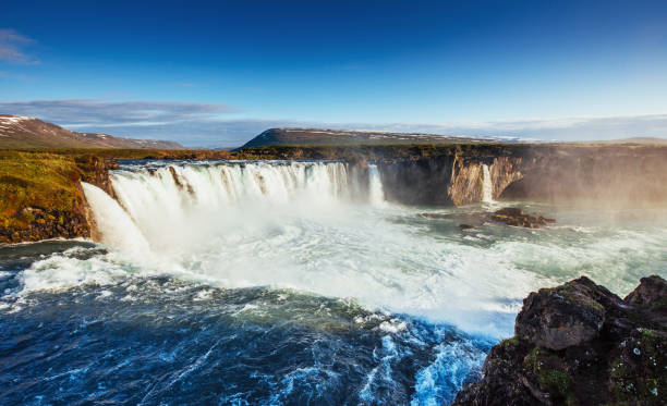 istock Godafoss waterfall at sunset. Fantastic landscape. Beautiful cumulus clouds. 849767922